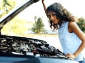 girl looking at car engine